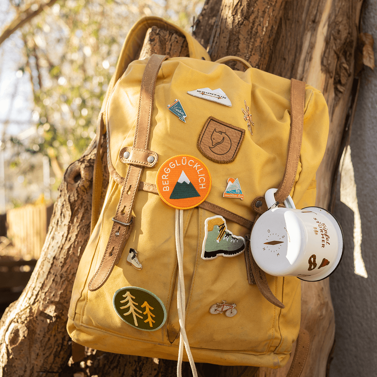 Anstecker und Patch Berg wald und Bergschuh an gelbem Rucksack