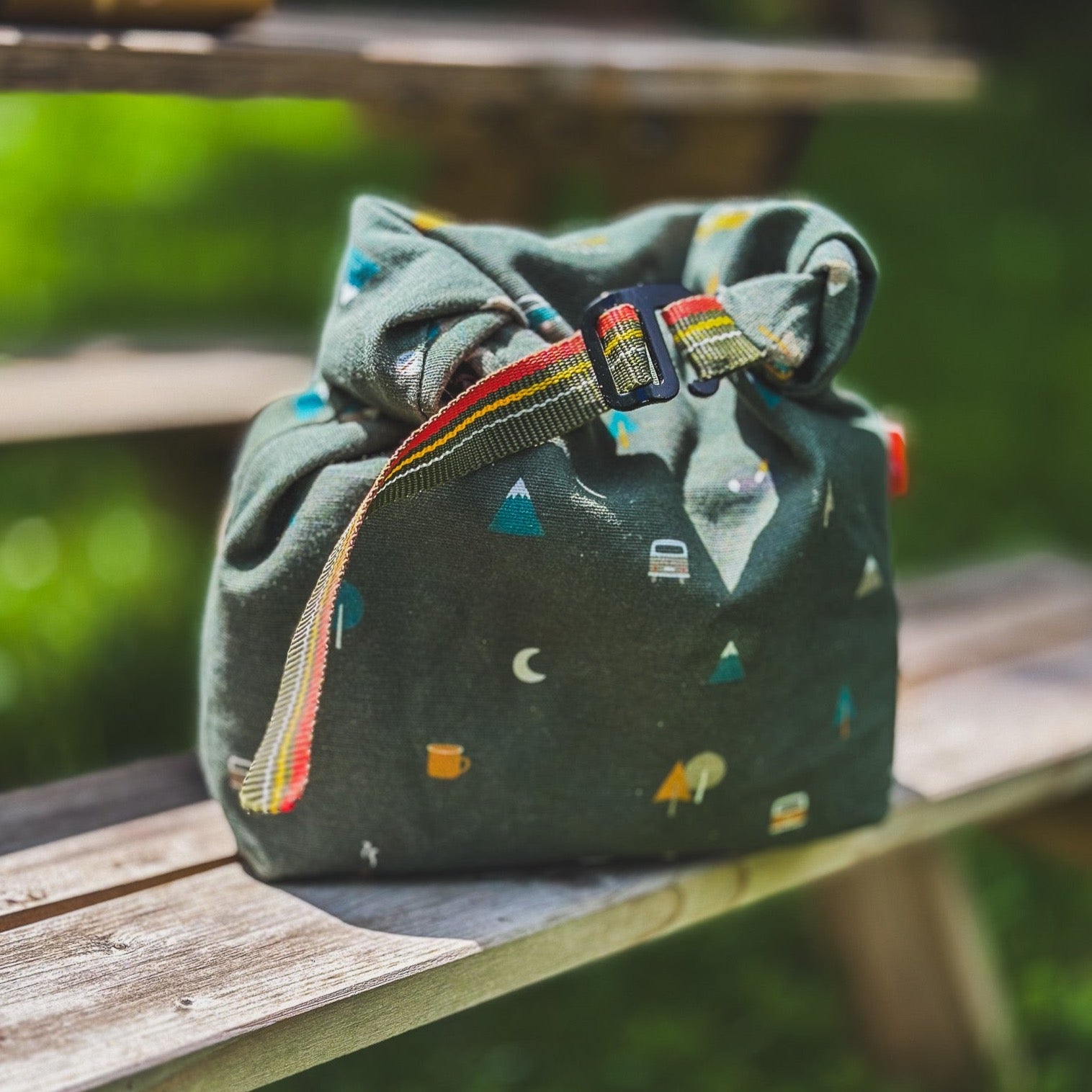 Grüner Lunchbag von Roadtyping mit Camping Accessoires auf Picknicktable